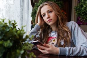 young girl with phone